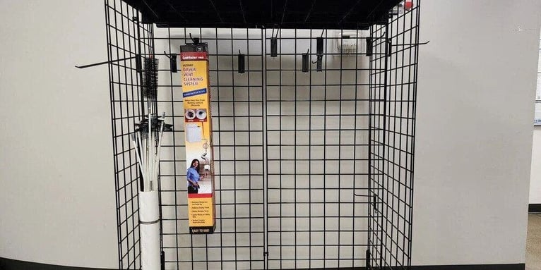 A LintEater Pro dryer vent cleaning kit hanging on a black retail display wire rack. It is the only product present.