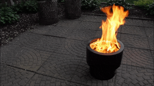 A Flame Genie Inferno smokeless firepit burning wood pellets on a patio