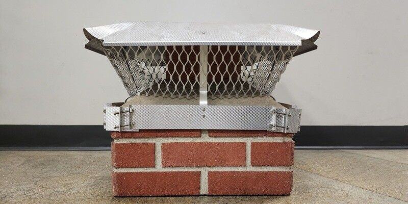 A Draft King Duro-Shield Band-Around-Brick Chimney Cap installed on a mock chimney flue.