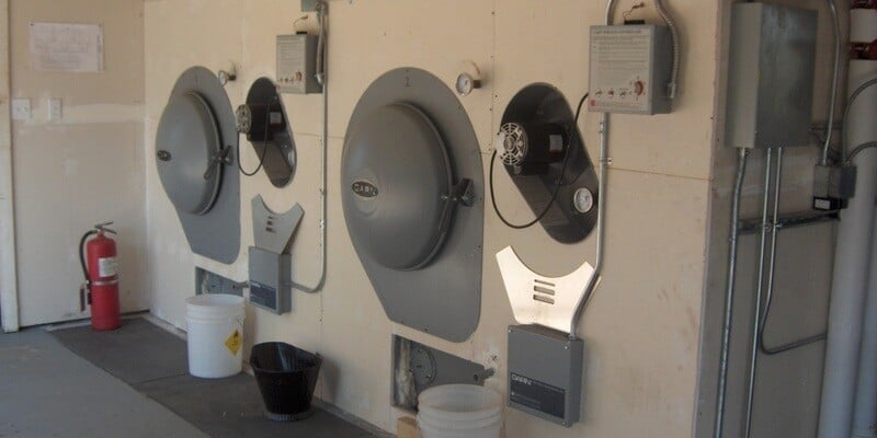 Two GARN wood boiler units installed in an outbuilding. They are encased in drywall with only their doors visible.