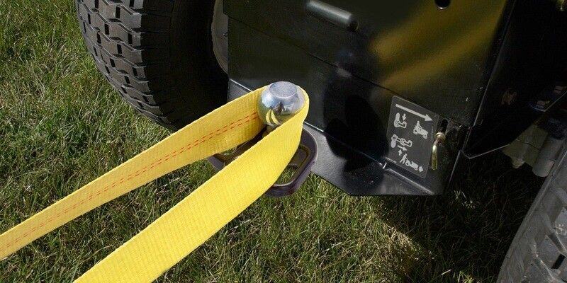 A close-up of a Good Vibrations Hitchin' Post+ 3-Way Hitch Plate installed on the back of a riding mower. A yellow nylon rope rests on the hitch.