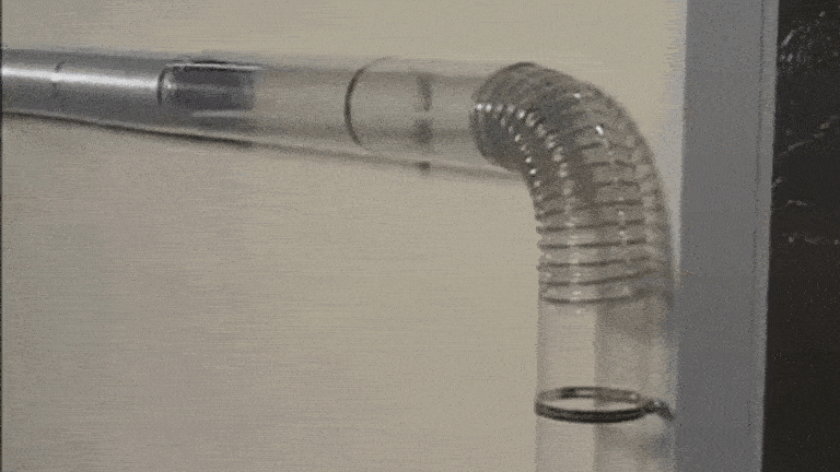 A GIF of LintEater dryer vent cleaning kit snaking its way through a transparent dryer vent for the sake of a demonstration.