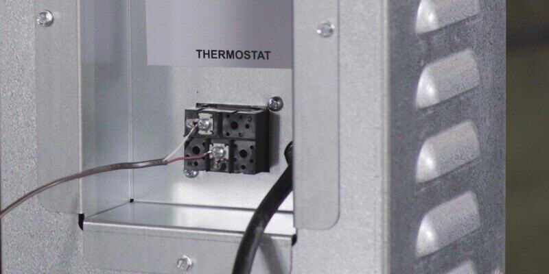 A close-up of the thermostat connection point on a Shelter SF1000E Wood Burning Furnace.