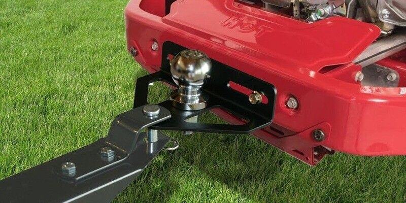 A Good Vibrations Z-Hitch Zero-Turn Mower Hitch Plate attached to a red zero-turn riding mower.