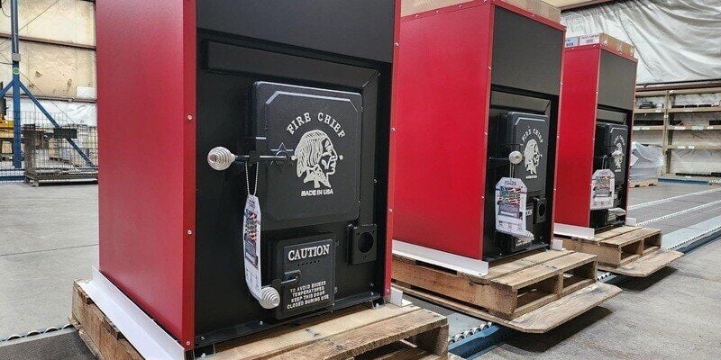 Three Fire Chief FC1000E wood burning furnaces on the production floor of the HY-C factory. They've just come off the line.