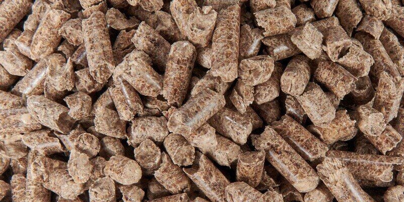 An extreme closeup of a pile of wood pellets. A few dozen pellets are visible onscreen.